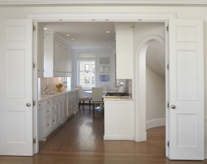 Curved Stair Residence — Through the double doors to the kitchen, with the arched passage formed at the end of the run